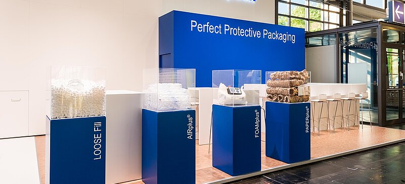 A Storopack trade fair stand with four blue display cases